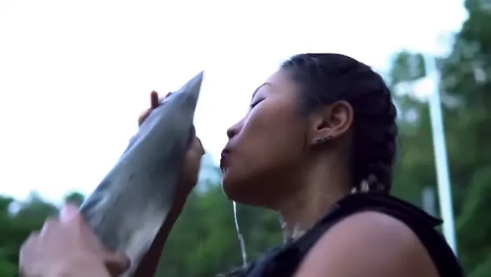 Athlete drinking from a water sleeve