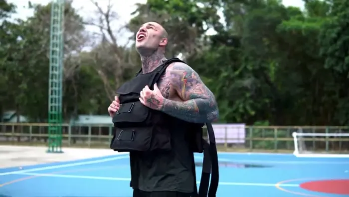 Fighter wrapping hands, wearing the vest